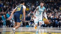 Charlotte Hornets guard LaMelo Ball (1) dribbles the ball while Indiana Pacers guard Ben Sheppard (26) defends in the first half at Gainbridge Fieldhouse.