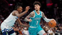 Charlotte Hornets guard LaMelo Ball (1) handles the ball against Minnesota Timberwolves guard Bones Hyland (8) during the second quarter at Spectrum Center.
