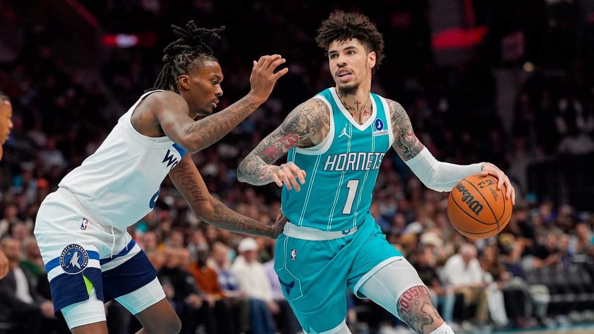 Charlotte Hornets guard LaMelo Ball (1) handles the ball against Minnesota Timberwolves guard Bones Hyland (8) during the second quarter at Spectrum Center.
