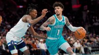 Charlotte Hornets guard LaMelo Ball (1) handles the ball against Minnesota Timberwolves guard Bones Hyland (8) during the second quarter at Spectrum Center.