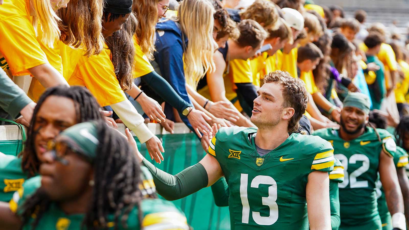 Baylor Bears quarterback Sawyer Robertson (13) high fives the fans in the student section following a game against the UCF Knights at McLane Stadium.