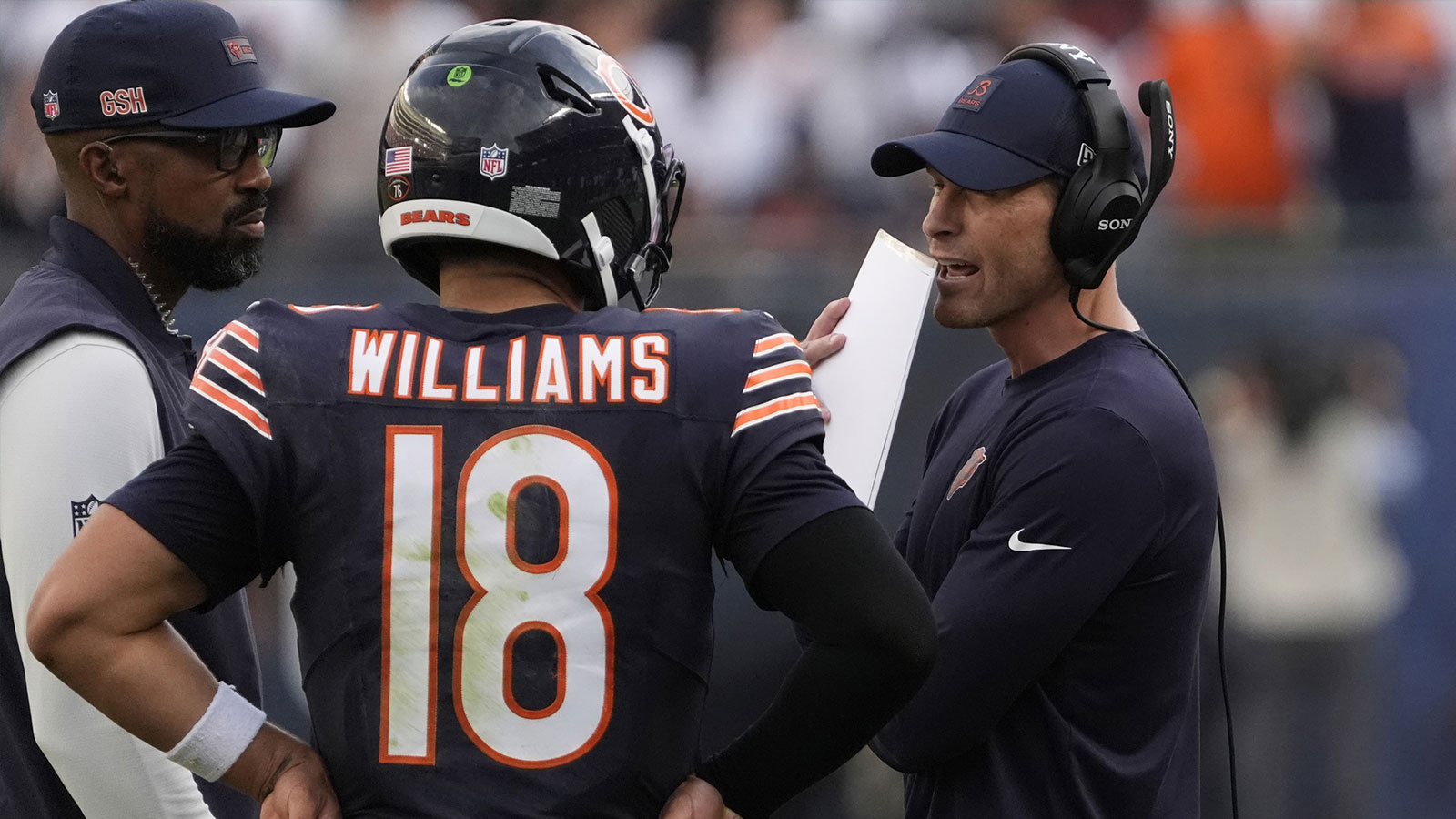 Chicago Bears head coach Ben Johnson talks with quarterback Caleb Williams (18) against the Dallas Cowboys during the second half at Soldier Field. 