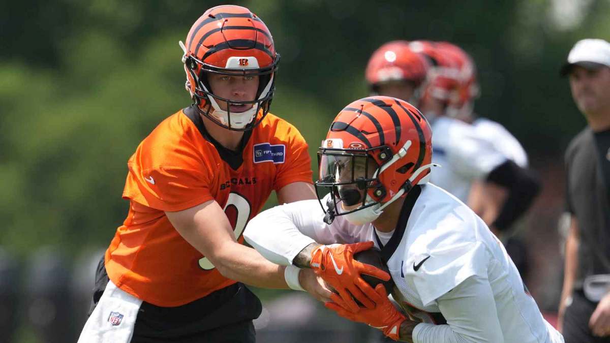 Cincinnati Bengals running back Chase Brown (30) takes a carry from quarterback Joe Burrow (9) during practice at Paycor Stadium. Mandatory Credit: Kareem Elgazzar-Imagn Images
