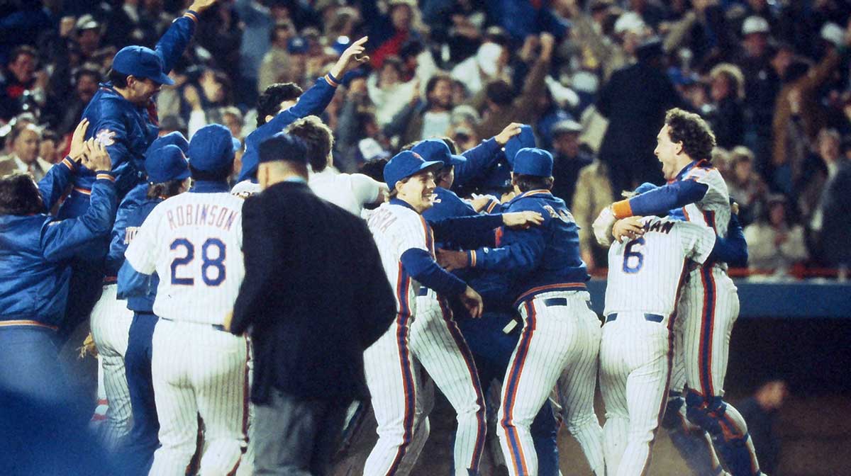 Mets players celebrate as Ray Knight jumps into the arms of teammates after scoring the game winning run on a ball hit by Mookie Wilson that got by Boston first basemen Bill Buckner in the bottom of the 10th inning during Game 6 of the World Series at Shea Stadium Oct. 25, 1986. Mets Vs Red Sox 1986 World Series