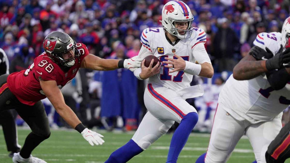 Buffalo Bills quarterback Josh Allen avoids Tampa Bay Buccaneers linebacker Anthony Nelson and runs for his third touchdown of the game during second half action against the Tampa Bay Buccaneers on Nov 16, 2025 at Highmark Stadium in Orchard Park.