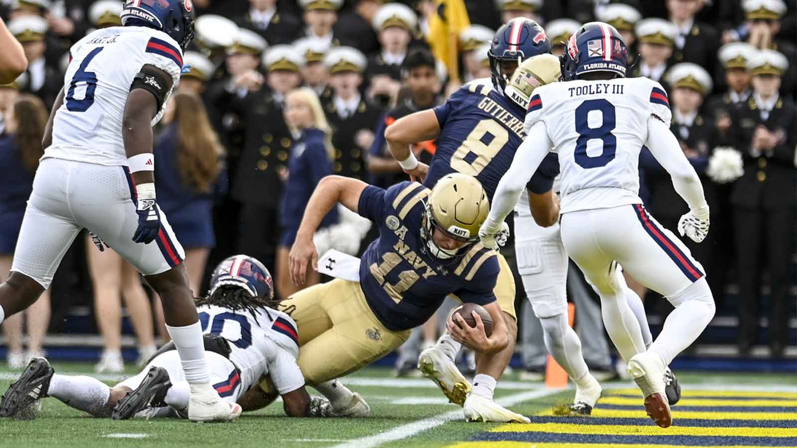 Navy Midshipmen quarterback Blake Horvath (11) dives for a touchdown as Florida Atlantic Owls safety Chris Keys Jr. (20) tackles during the first half at Navy-Marine Corps Memorial Stadium.