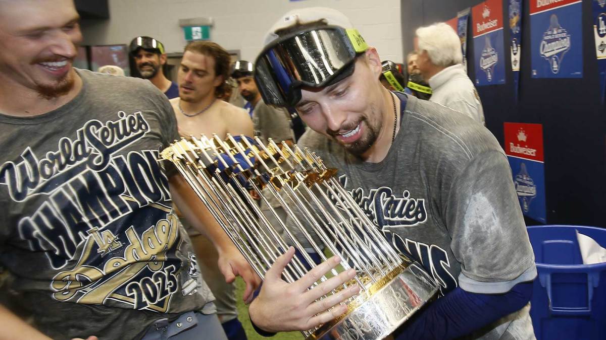 Los Angeles Dodgers pitcher Blake Snell (7) celebrates with the Commissioner's Trophy in the locker room after defeating the Toronto Blue Jays in the 2025 MLB World Series at Rogers Centre.