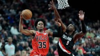 Chicago Bulls forward Isaac Okoro (35) goes up for a shot under pressure from Portland Trail Blazers forward Jerami Grant (9) during the second half at Moda Center.