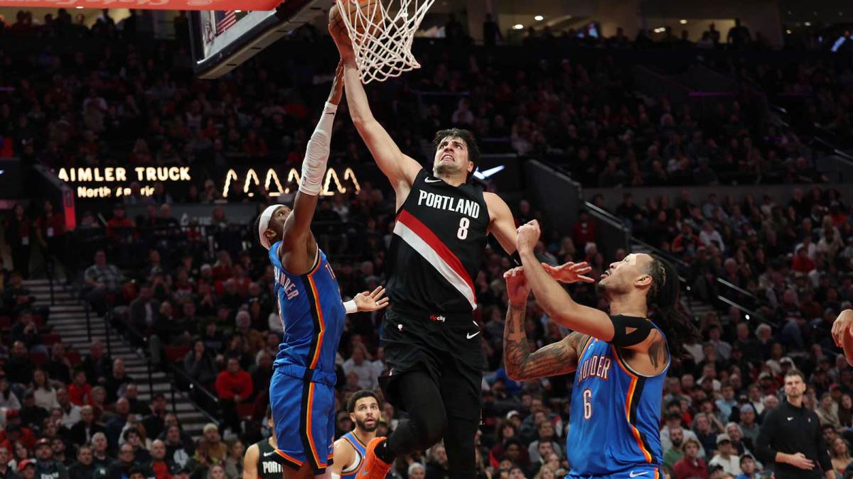 Portland Trail Blazers forward Deni Avdija (8) dunks the ball over Oklahoma City Thunder guard Shai Gilgeous-Alexander (2) and Thunder’s forward Jaylin Williams (6) during the second half at Moda Center