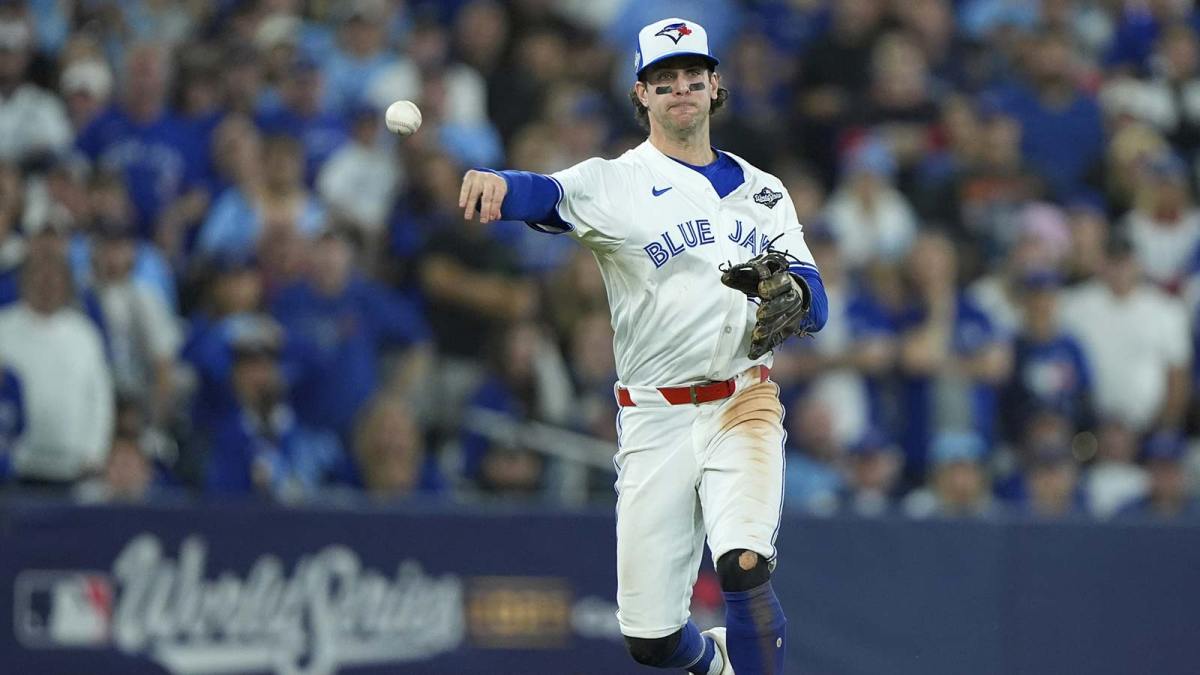 Blue Jays third baseman Ernie Clement (22) throws to first
