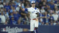 Blue Jays third baseman Ernie Clement (22) throws to first