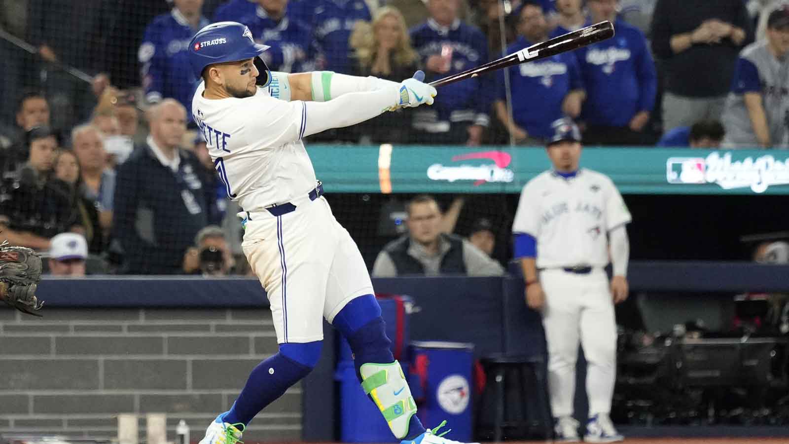 Toronto Blue Jays designated hitter Bo Bichette (11) hits a single against the Los Angeles Dodgers in the ninth inning during game seven of the 2025 MLB World Series at Rogers Centre. Mandatory Credit: