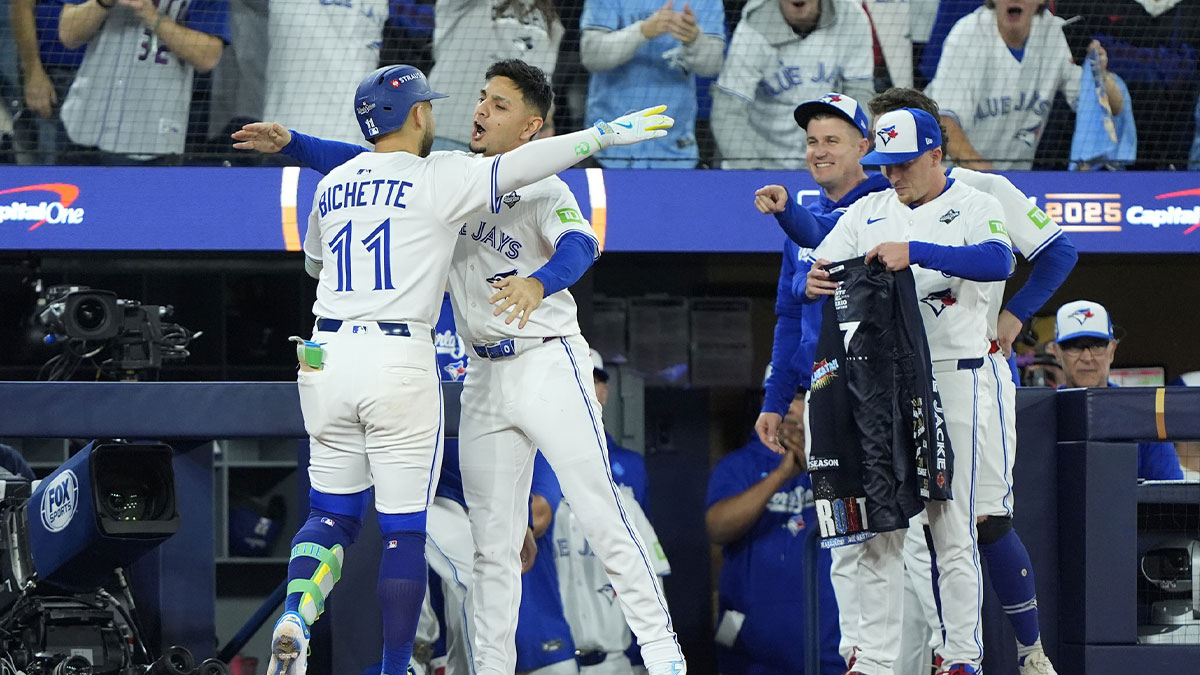 Toronto Blue Jays designated hitter Bo Bichette (11) celebrates with shortstop Andres Gimenez (0) after hitting a three run home run against the Los Angeles Dodgers in the third inning during game seven of the 2025 MLB World Series at Rogers Centre.