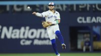 Toronto Blue Jays designated hitter Bo Bichette (11) throws to first for an out against Los Angeles Dodgers right fielder Teoscar Hernandez (37) in the eighth inning during game seven of the 2025 MLB World Series at Rogers Centre.