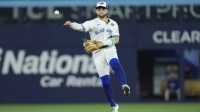 Toronto Blue Jays designated hitter Bo Bichette (11) throws to first for an out against Los Angeles Dodgers right fielder Teoscar Hernandez (37) in the eighth inning during game seven of the 2025 MLB World Series at Rogers Centre.