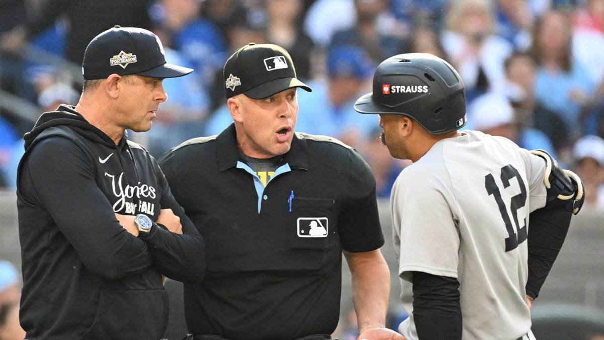 New York Yankees manager Aaron Boone (17) and center fielder Trent Grisham (12) talk to home plate umpire Chris Segal in the first inning against the Toronto Blue Jays during game one of the ALDS round for the 2025 MLB playoffs at Rogers Centre