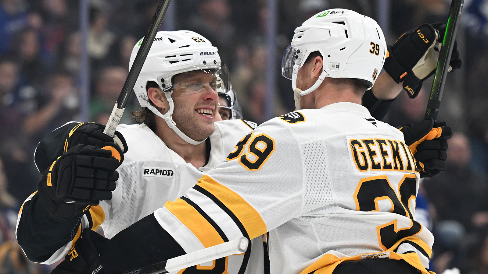  Boston Bruins forward David Pastrnak (88) celebrates with forward Morgan Geekie (39) after scoring a goal against the Toronto Maple Leafs in the second period at Scotiabank Arena.
