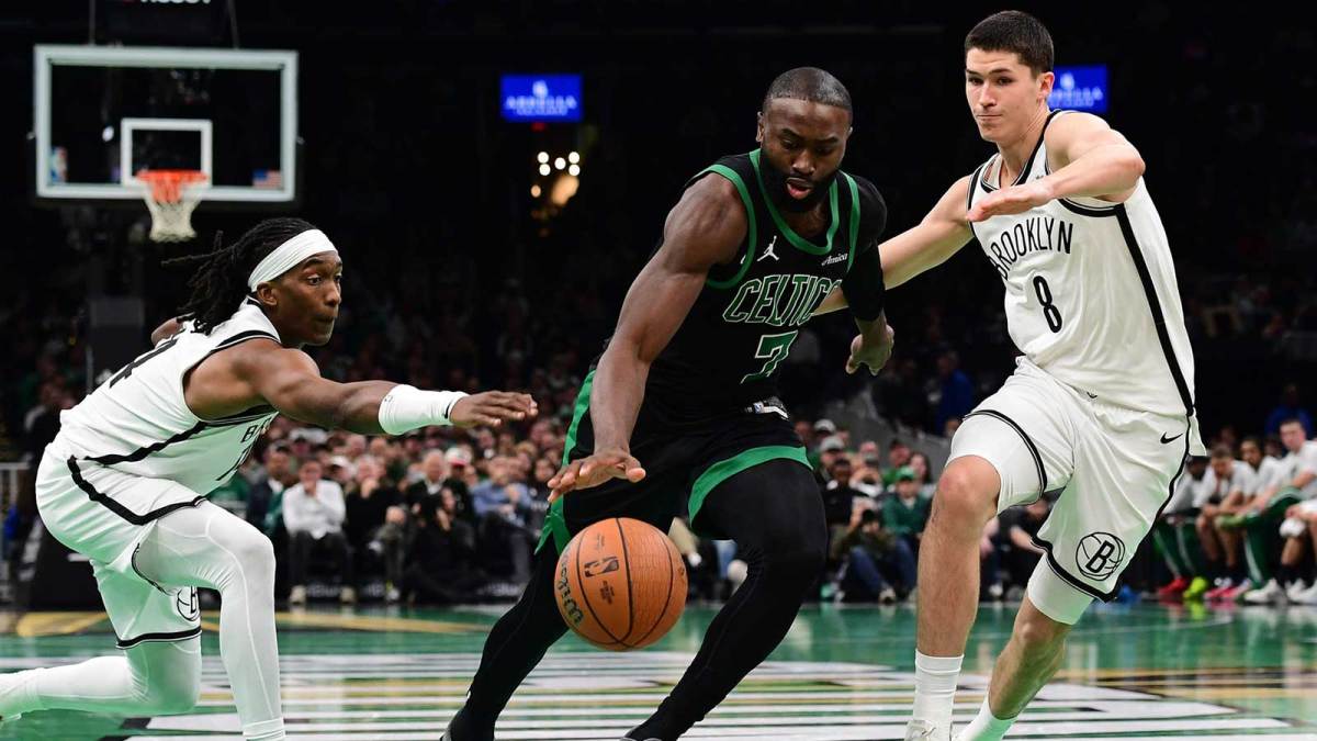 Boston Celtics guard Jaylen Brown (7) controls the ball between Brooklyn Nets guard Terance Mann (14) and guard Egor Demin (8) during the second half at TD Garden.