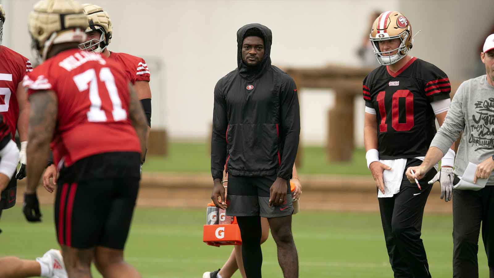 San Francisco 49ers wide receiver Brandon Aiyuk (in black hoodie) watches his teammates work out during the second day of training camp. 
