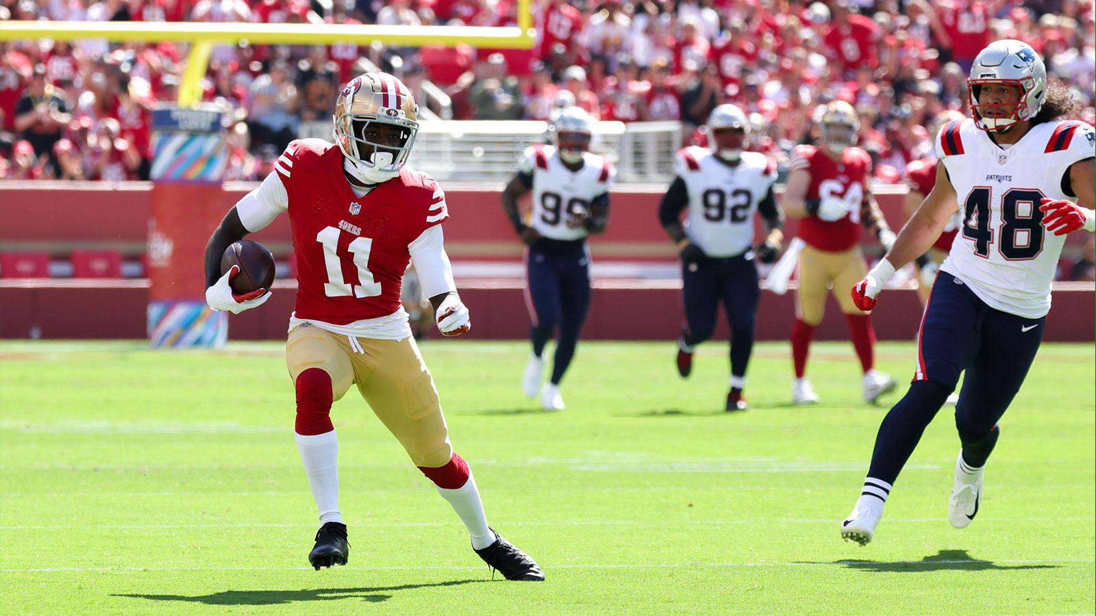 San Francisco 49ers wide receiver Brandon Aiyuk (11) runs with the ball past New England Patriots linebacker Jahlani Tavai (48) during the first quarter at Levi's Stadium. 