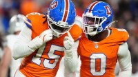 Denver Broncos linebacker Nik Bonitto (15) and linebacker Jonathon Cooper (0) react during the first half at Empower Field at Mile High.