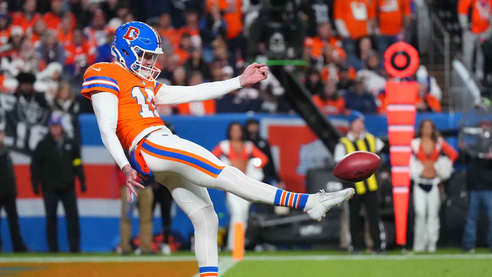 Denver Broncos punter Jeremy Crawshaw (16) punts the ball against the Las Vegas Raiders during the first half at Empower Field at Mile High.