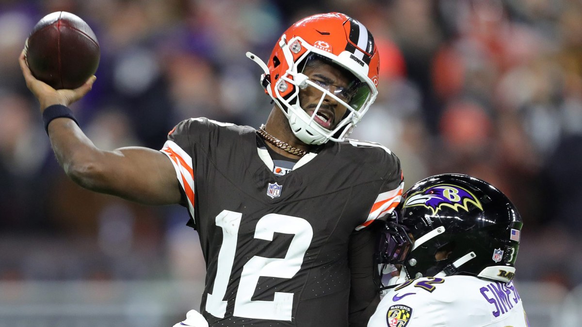 Cleveland Browns quarterback Shedeur Sanders (12) is hit by Baltimore Ravens linebacker Trenton Simpson (32) during the second half of an NFL football game at Huntington Bank Field, Nov. 16, 2025, in Cleveland, Ohio.