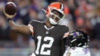 Cleveland Browns quarterback Shedeur Sanders (12) is hit by Baltimore Ravens linebacker Trenton Simpson (32) during the second half of an NFL football game at Huntington Bank Field, Nov. 16, 2025, in Cleveland, Ohio.