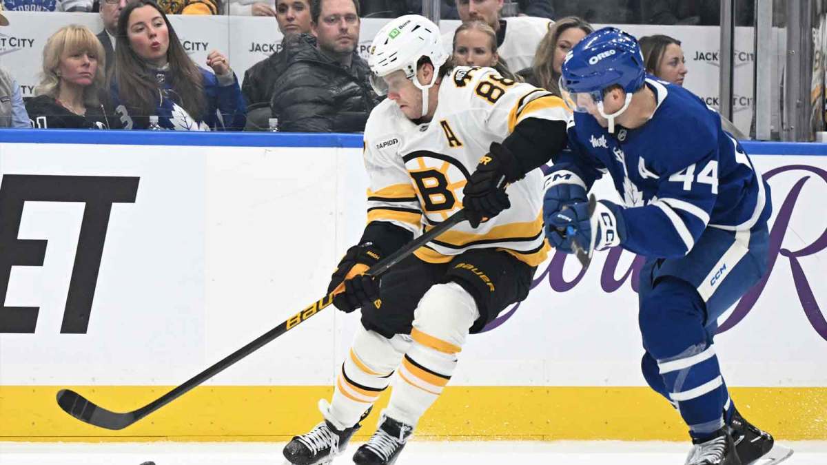Boston Bruins forward David Pastrnak (88) moves the puck past Toronto Maple Leafs defenseman Morgan Rielly (44) in the second period at Scotiabank Arena.