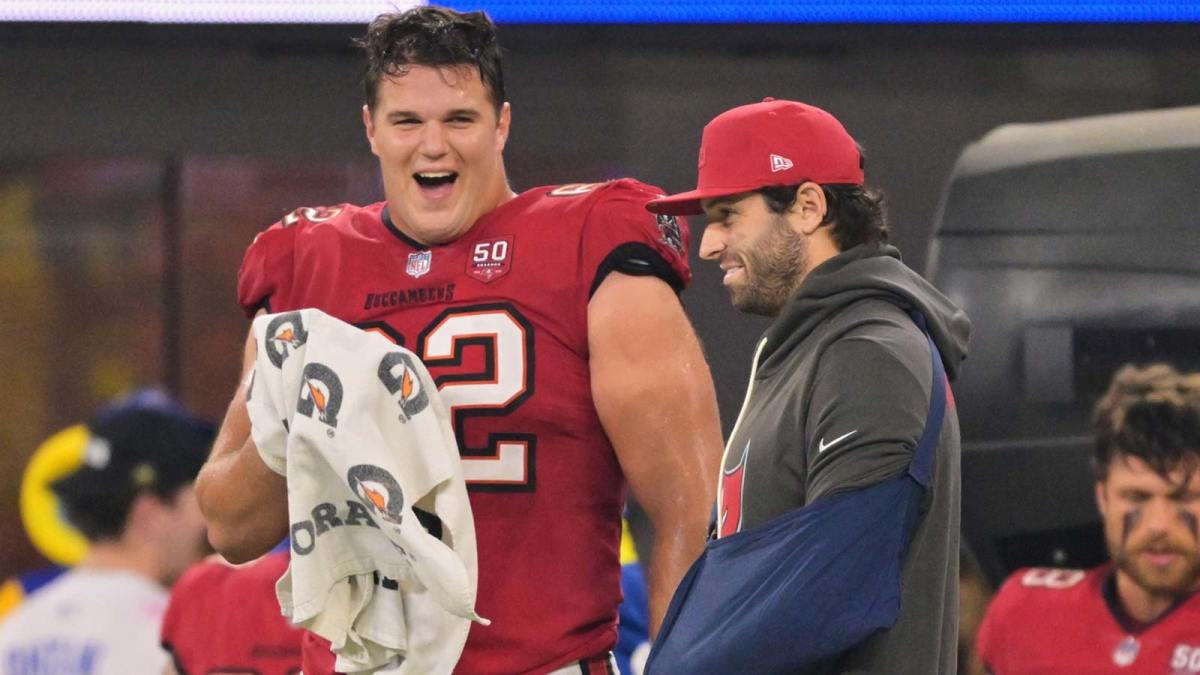 Tampa Bay Buccaneers quarterback Baker Mayfield (6) stands on the sideline with his left arm in a sling and chats with center Graham Barton (62) during the fourth quarter against the Los Angeles Rams at SoFi Stadium.