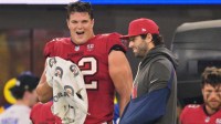 Tampa Bay Buccaneers quarterback Baker Mayfield (6) stands on the sideline with his left arm in a sling and chats with center Graham Barton (62) during the fourth quarter against the Los Angeles Rams at SoFi Stadium.