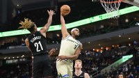 Milwaukee Bucks center Myles Turner (3) dunks the ball against Brooklyn Nets forward Noah Clowney (21) and forward Danny Wolf (2) in the second quarter at Fiserv Forum.