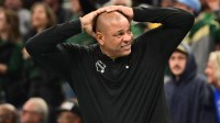 Bucks head coach Doc Rivers reacts in the 4th quarter against the Chicago Bulls at Fiserv Forum with Mavericks' Luka Doncic in the background