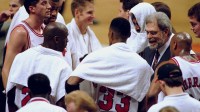 Chicago Bulls coach Phil Jackson, right, with team (clockwise from Phil) Scott Burrell (24), Scottie Pippen (33), Michael Jordan (23), Toni Kukoc (7), Dickey Simpkins (8), Steve Kerr (25) and Dennis Rodman (91) during a game against the Detroit Pistons at the United Center.