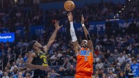 Oklahoma City Thunder guard Shai Gilgeous-Alexander (2) shoots as Golden State Warriors forward Jimmy Butler III (10) defends during the first quarter at Paycom Center.