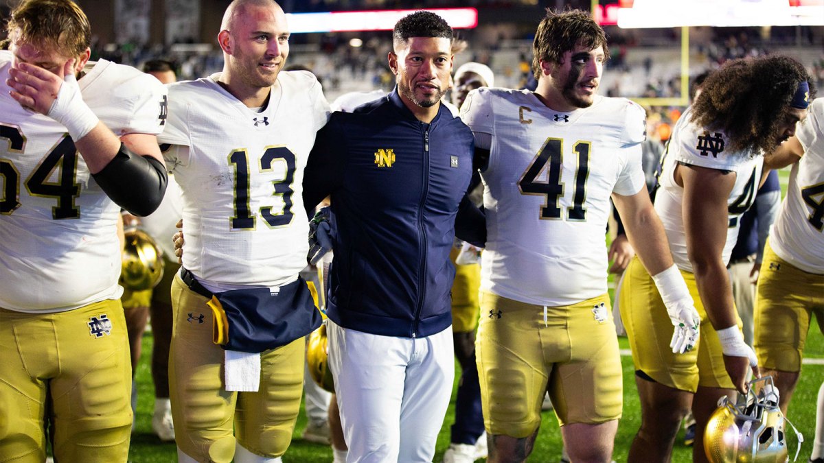 Notre Dame Fighting Irish head coach Marcus Freeman, Notre Dame Fighting Irish quarterback CJ Carr (13) and Notre Dame Fighting Irish defensive lineman Donovan Hinish (41) after the game against the Boston College Eagles at Alumni Stadium.