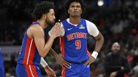 Detroit Pistons guard Cade Cunningham (2) and forward Ausar Thompson (9) chat against the Chicago Bulls during the second half at the United Center.