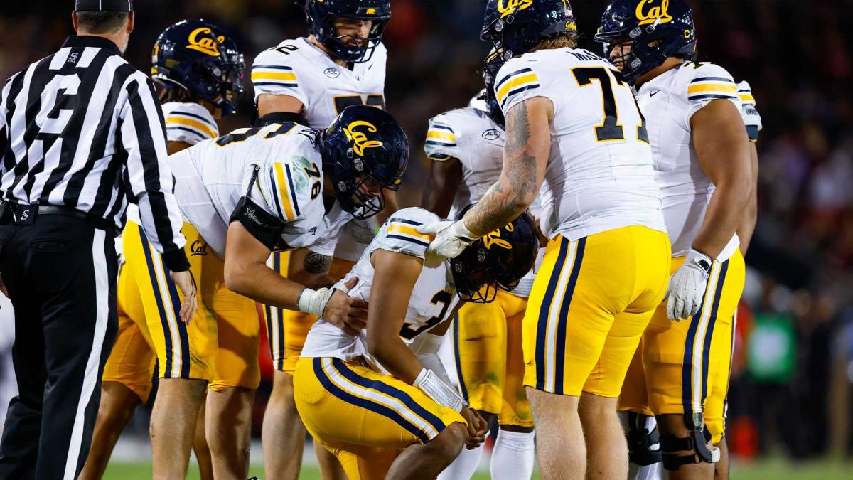 California Golden Bears quarterback Jaron-Keawe Sagapolutele (3) is helped up by his offensive line after a sack during the fourth quarter against the Stanford Cardinal at Stanford Stadium.