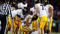 California Golden Bears quarterback Jaron-Keawe Sagapolutele (3) is helped up by his offensive line after a sack during the fourth quarter against the Stanford Cardinal at Stanford Stadium.