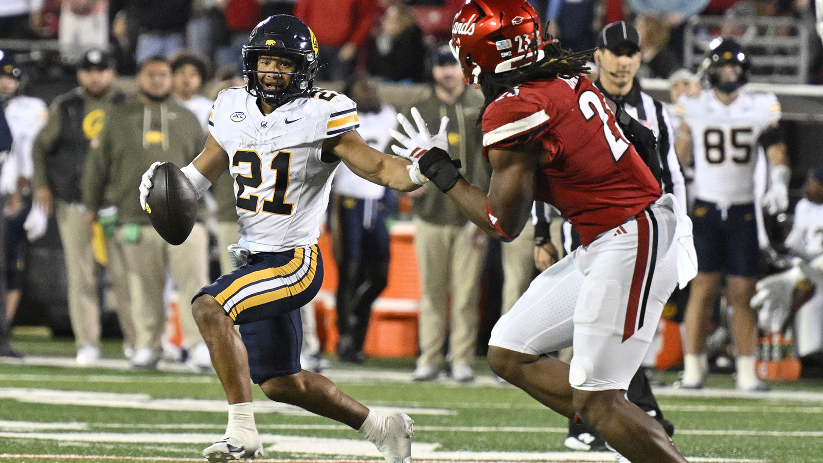 California Golden Bears wide receiver Jacob de Jesus (21) runs the ball against Louisville Cardinals defensive lineman Wesley Bailey (23) in overtime at L&N Federal Credit Union Stadium. California defeated Louisville 29-26.
