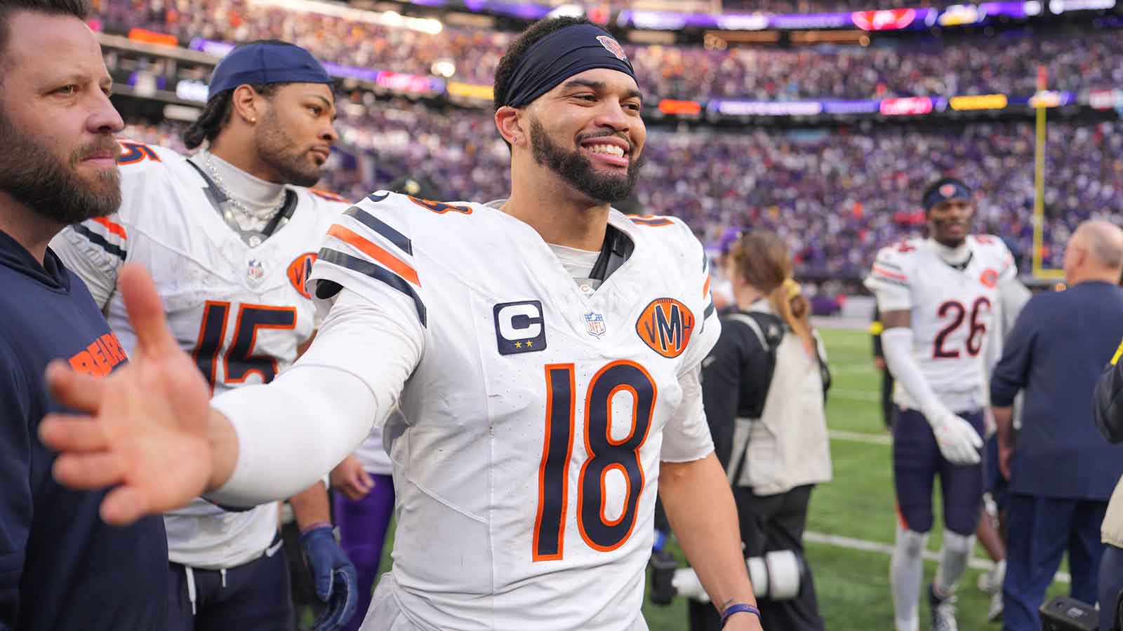 Chicago Bears quarterback Caleb Williams (18) greets a Minnesota Vikings player following a game at U.S. Bank Stadium.