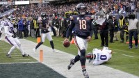 Chicago Bears quarterback Caleb Williams (18) scores the game-winning touchdown against New York Giants linebacker Brian Burns (0) during the fourth quarter at Soldier Field.