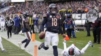 Chicago Bears quarterback Caleb Williams (18) scores the game-winning touchdown against New York Giants linebacker Brian Burns (0) during the fourth quarter at Soldier Field.