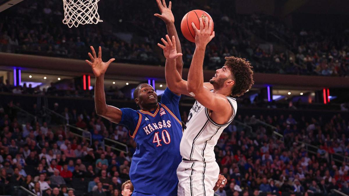 Duke Blue Devils forward Cameron Boozer (12) shoots the ball as Kansas Jayhawks forward Flory Bidunga (40) defends during the second half at Madison Square Garden.