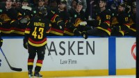 Vancouver Canucks defenseman Quinn Hughes (43) celebrates scoring with teammates on the bench during the third period against the Calgary Flames at Rogers Arena.