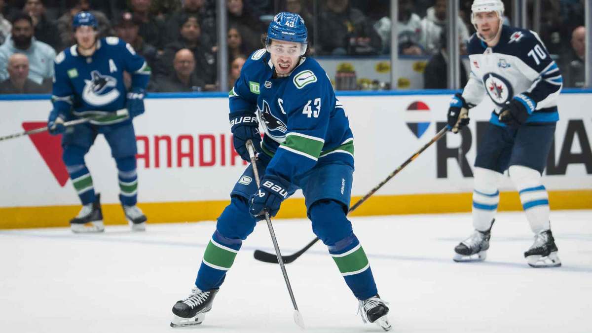 Vancouver Canucks defenseman Quinn Hughes (43) handles the puck against the Winnipeg Jets in the second period at Rogers Arena.