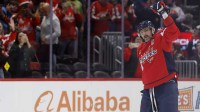 Washington Capitals left wing Alex Ovechkin (8) waves to the crowd after scoring his 900th NHL goal, against the St. Louis Blues, during the second period at Capital One Arena.