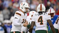 Miami Hurricanes quarterback Carson Beck (11) sets the play with running back Mark Fletcher Jr. (4) during the first quarter against the SMU Mustangs at Gerald J. Ford Stadium.