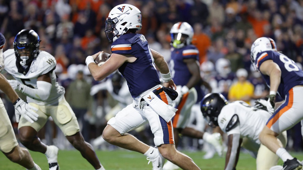 Virginia Cavaliers quarterback Chandler Morris (4) runs with the ball and is injured on the play during the first half against the Wake Forest Demon Deacons at Scott Stadium.