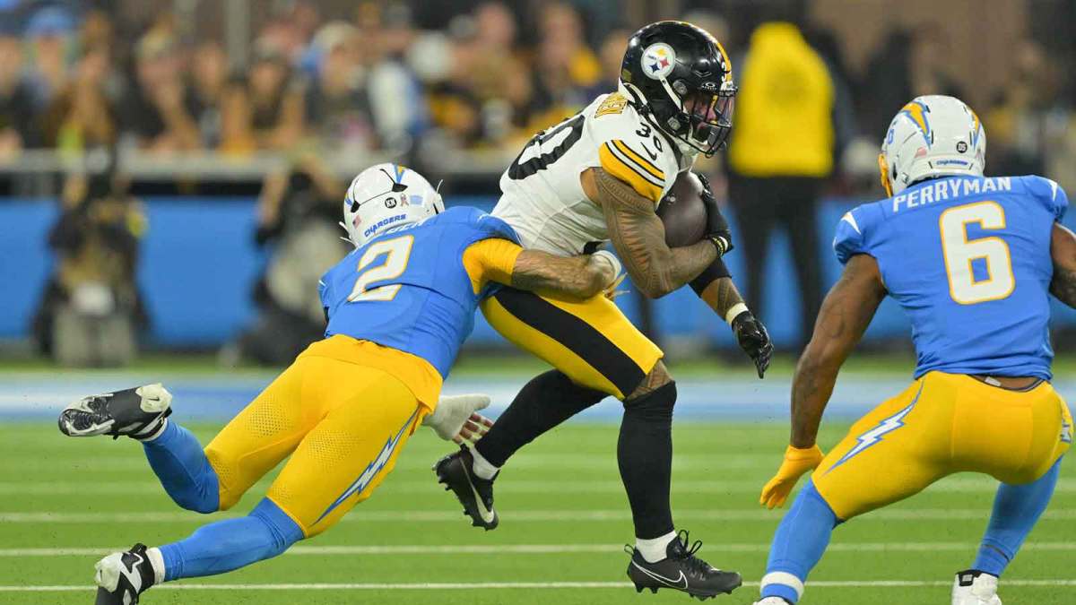 Los Angeles Chargers cornerback Elijah Molden (2) tackles Pittsburgh Steelers running back Jaylen Warren (30) during the first quarter of the game at SoFi Stadium.